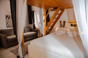 a bedroom with a bed with a ladder and a chair at Loge du Vieux Lyon Chambre d'hôtes in Lyon