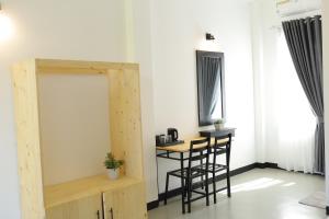 a room with two bar stools and a table at Ayurya Wellness Retreat in Kandy