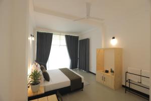 a bedroom with a large bed and a window at Ayurya Wellness Retreat in Kandy