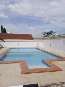 a large swimming pool in the middle of a building at Stallion Luxury Suites Mararaba in Abuja +19 photos