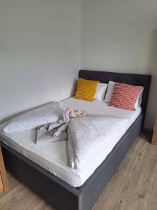 a bed with several pillows on top of it at Green Studio Martin in Martin