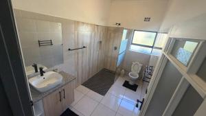 a small bathroom with a sink and a toilet at Siwela in Darkton