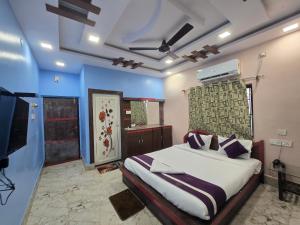 a bedroom with a bed and a television in it at JBL Beach Resort Mandarmoni in Mandarmoni +76 photos