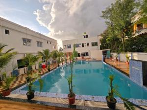 a large swimming pool next to a building at JBL Beach Resort Mandarmoni in Mandarmoni