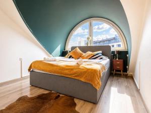 a bed in a room with a large window at 10-Min Walk to Hauptbahnhof, Cozy Private Rooms with AC, TV & WIFI in Vienna +110 photos