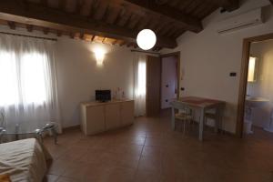 a room with a bed and a table and a desk at Locanda Veneta in Vicenza