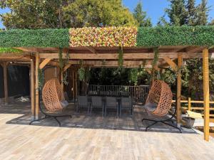 a patio with a table and chairs under a pergola at Villa avec piscine à Super Cannes in Vallauris