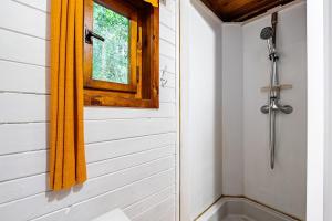 a bathroom with a shower and a window at Cottage kingfisher  +19 photos