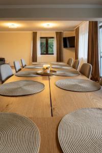 a conference room with rows of tables and chairs at Vila dintre Brazi in Râu de Mori