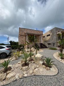 a house with a car parked in front of it at WAAP Hotel in Ishigaki Island