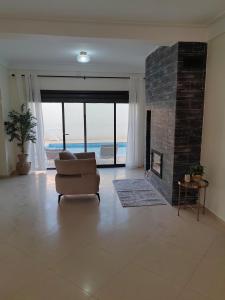 a living room with a couch and a fireplace at Villa Lila in Cherchell
