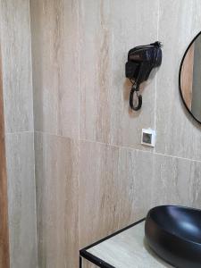a phone hanging on a wall next to a table at Villa Lila in Cherchell