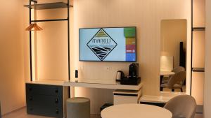 a room with a flat screen tv on a wall at Manoli Luxury Rooms in Vieste
