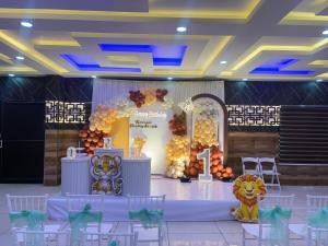 a stage in a room with a lion backdrop at Odyssey Rendezvous in Chottanikara