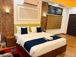 a bedroom with a large bed in a room at Odyssey Rendezvous in Chottanikara