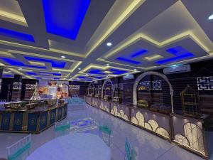 a restaurant with blue lights on the ceiling at Odyssey Rendezvous in Chottanikara