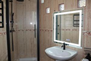 a bathroom with a sink and a mirror at Casa Nido in Ríogordo +23 photos