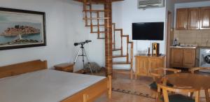 a living room with a spiral staircase and a kitchen at Amore apartments in Budva