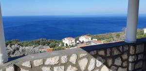 a view of the ocean from a wall at Amore apartments in Budva