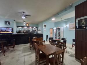 a restaurant with tables and chairs and a bar at Hotel Bar Restorant RRAHIMI in Shënmëri