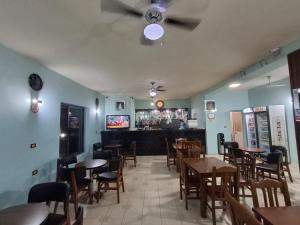 a restaurant with tables and chairs and a bar at Hotel Bar Restorant RRAHIMI in Shënmëri