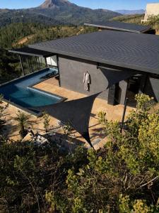 an overhead view of a house with a person on the roof at Loft Vilas Boas in Nova Lima +12 photos