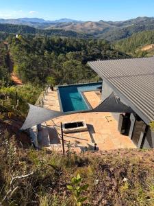 an image of a house with a swimming pool at Loft Vilas Boas in Nova Lima