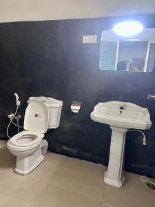 a bathroom with a toilet and a sink at Villa77 Benthota in Bentota