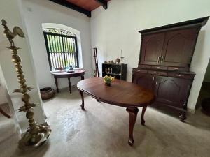 a living room with a wooden table in a room at Villa77 Benthota in Bentota +22 photos