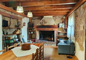 a living room with a table and a fireplace at Casa rural Más La Torreta con vistas al Pla de Vistabella cerca del Peñagolosa Pet Friendly niños gratis in Vistabella del Maestrazgo