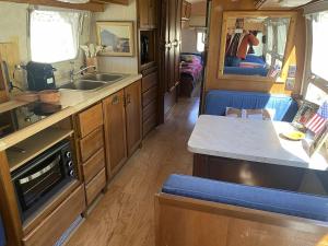 a kitchen in an rv with a sink and a counter at Le Stéréo Motel in LʼHospitalet