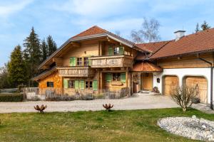a large wooden house with a porch at Luxury Chalet with Swimming Pond Nature Escape Upper Austria in Sankt Johann am Walde