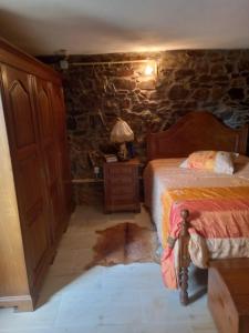 a bedroom with a bed and a table with a lamp at Casinha Meixedo in Bragança