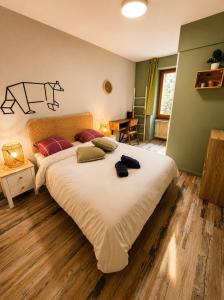 a bedroom with a large white bed and a table at 1861 Châtel Hostel in Châtel +84 photos