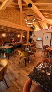 a restaurant with tables and chairs in a room at 1861 Châtel Hostel in Châtel