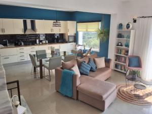 a living room with a couch and a table at Villa dionysus in Acharavi