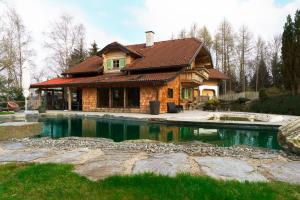 a house with a swimming pool in front of it at Luxury Chalet with Swimming Pond Nature Escape Upper Austria in Sankt Johann am Walde