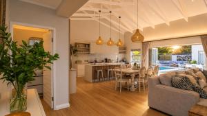 a kitchen and living room with a couch and a table at Robin Retreat - Luxury 3 Bedroom Villa -Hermanus in Hermanus