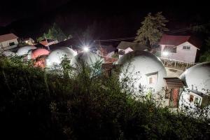 a bunch of domes are lined up at night at Jeongsun Hayandom Pension in Jeongseon