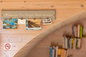 a book shelf with books in a library at Finest Retreats - Idris Pod in St Asaph