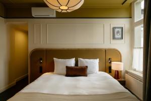 a bedroom with a bed with a pillow on it at Hotel Kasteel Doenrade in Doenrade