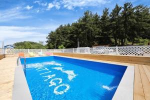 a blue swimming pool with the words on it at Samcheok santiago pension in Samcheok
