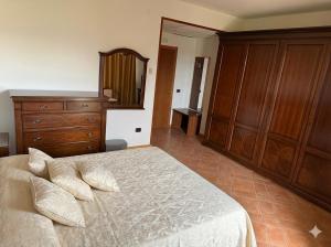a bedroom with a bed and a dresser and a mirror at Locanda Panorama Picerno in Picerno