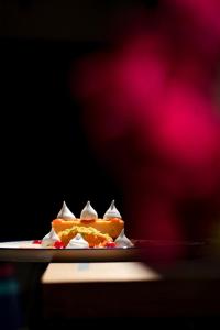 a plate of food with whipped cream and sauce at Imola Udvarház Dessert Hotel in Eger
