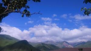 a view of mountains with a blue sky and clouds at Maias guest house in Kazbegi