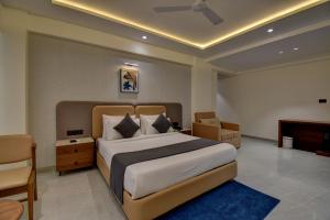 a bedroom with a large bed and a television at Hotel Sai Mahima, Near Sai Baba Temple in Shirdi +63 photos