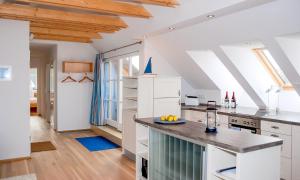 a kitchen with white cabinets and a counter at Am Kranichland in Wieck
