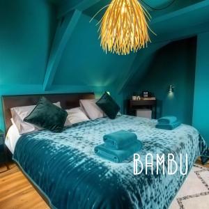 a blue bedroom with a bed with blue sheets at Bambu Kitchen & Bar - Hotel Restaurant in Haarlem