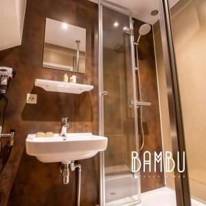 a bathroom with a sink and a shower at Bambu Kitchen & Bar - Hotel Restaurant in Haarlem +26 photos