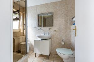 a bathroom with a sink and a toilet at Sonnenblumenhaus 01 in Prerow +20 photos
